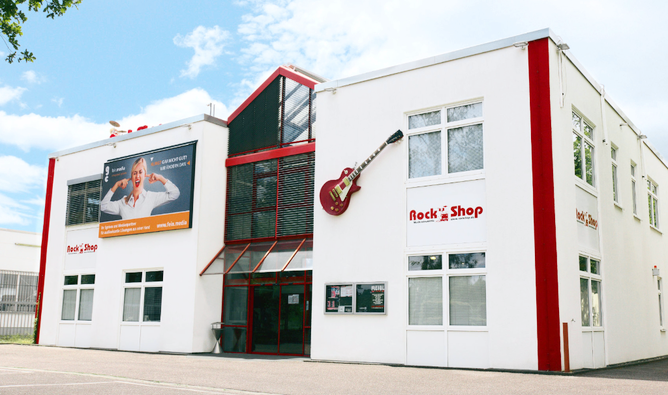 Rock Shop Karlsruhe – exterior of the music retail store Exterior view of the Rock Shop building in Karlsruhe with a red guitar on the facade